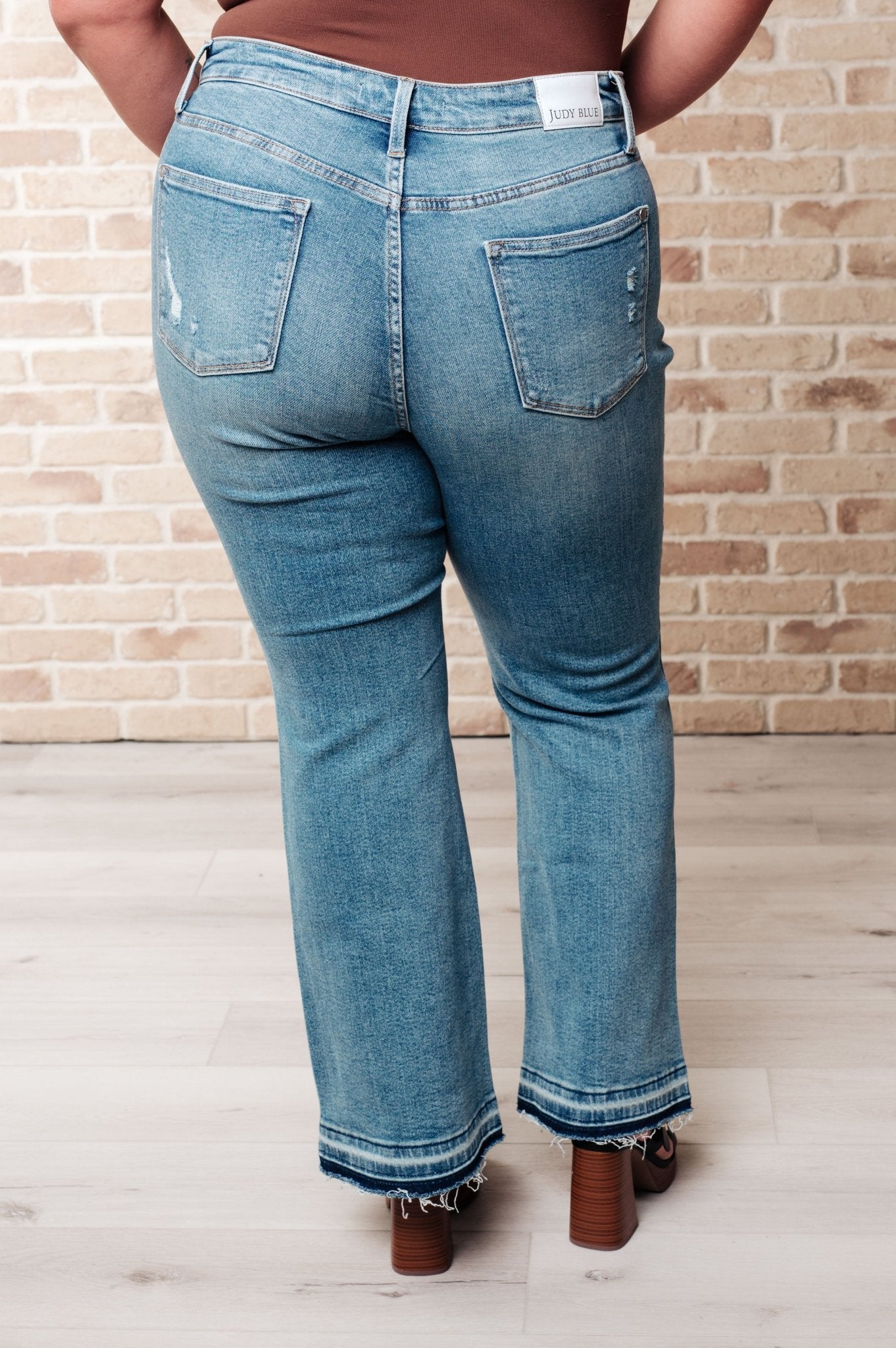 Isla Mid Rise Distressed Released Hem Bootcut Jeans - Driftwood Boutique