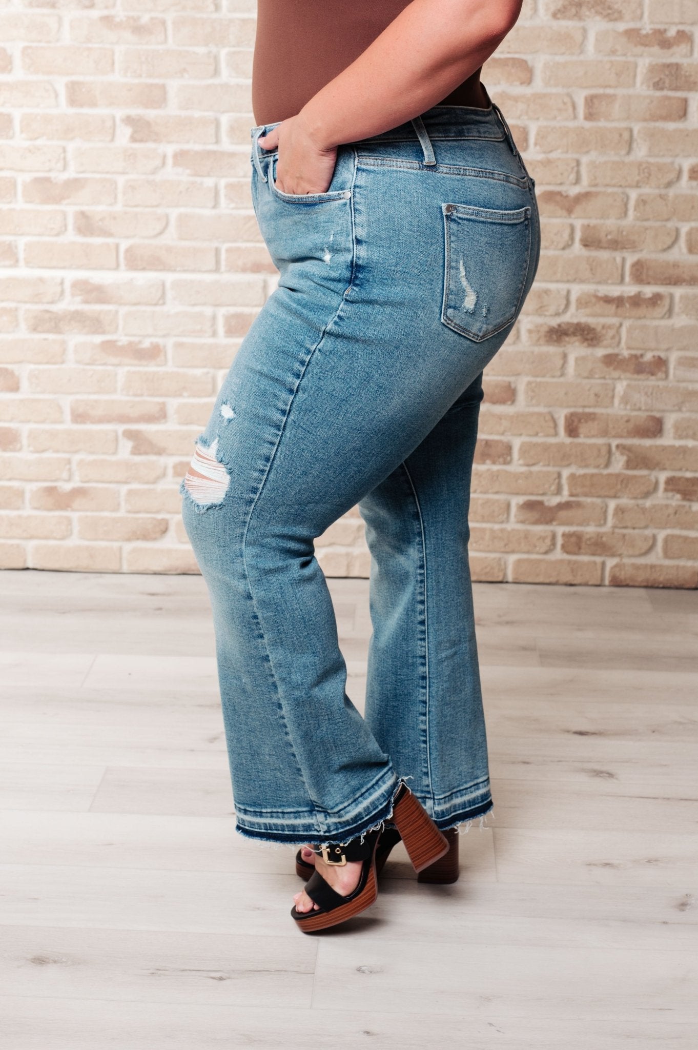 Isla Mid Rise Distressed Released Hem Bootcut Jeans - Driftwood Boutique