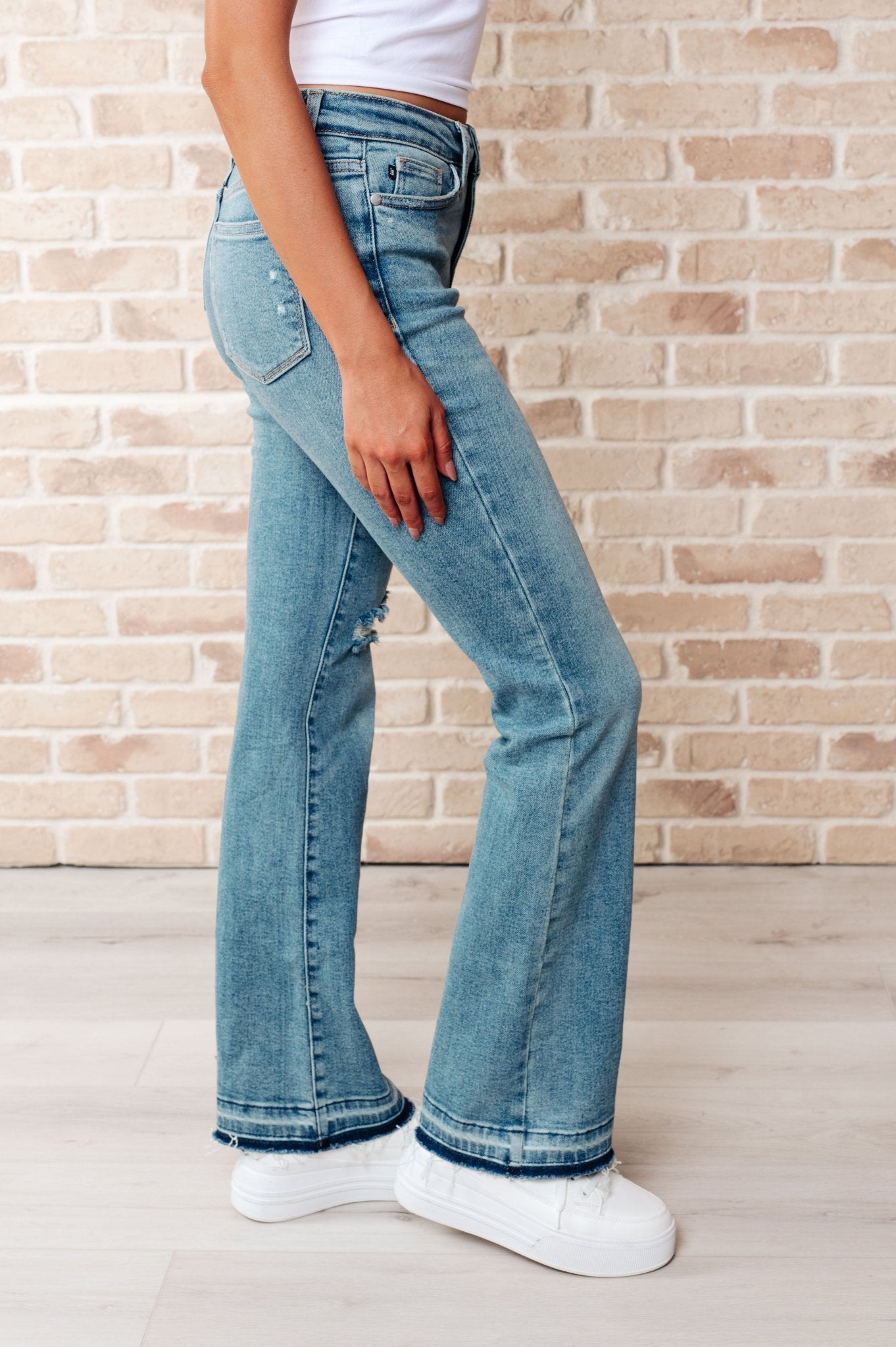 Isla Mid Rise Distressed Released Hem Bootcut Jeans - Driftwood Boutique
